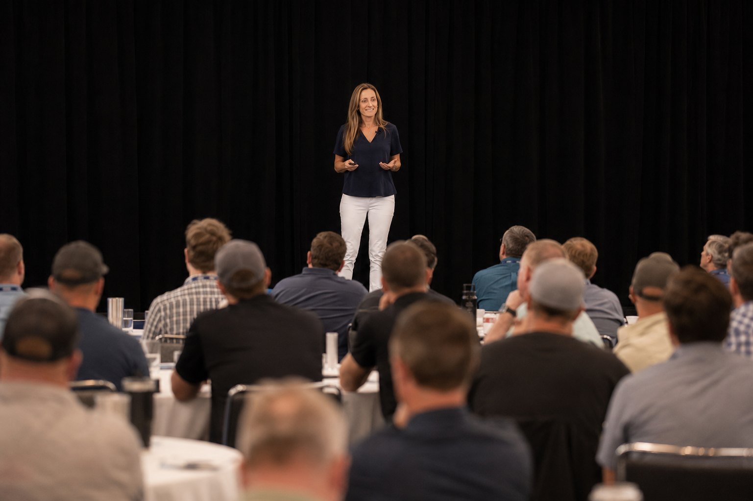 Polly Mertens speaking to a room of construction professionals